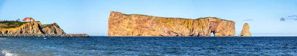 Rocher Perce rock in Gaspe Peninsula, Quebec, Gaspesie region, Canada. Famous landmark in blue Saint Lawrence gulf water. stock photo