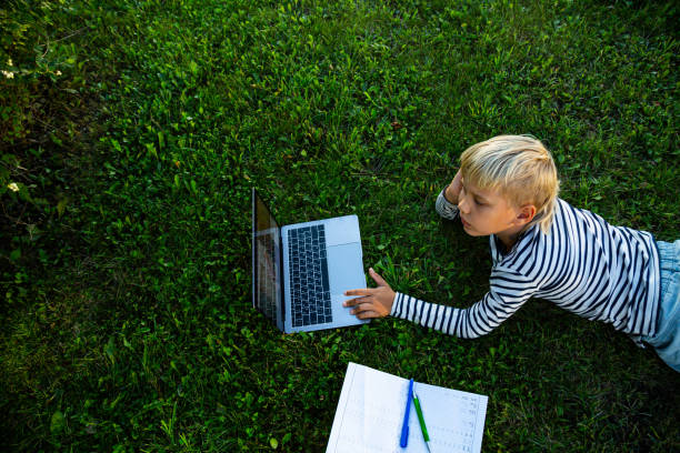 istock The boy is engaged in the Internet outdoors. 1269543837