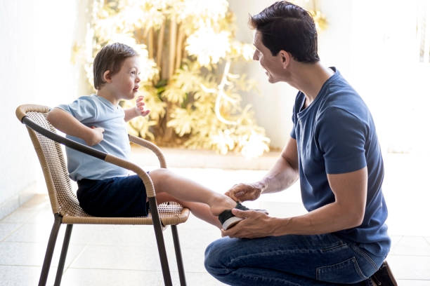istock Father preparing his son to go back to school. Down sindrome. 1269544630
