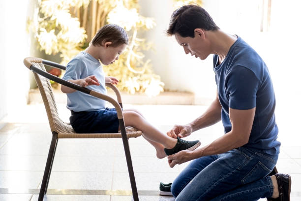 istock Father preparing his son to go back to school. Down sindrome. 1269544641