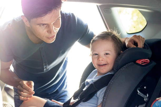 istock Father preparing his son to go back to school. Down sindrome. 1269544904