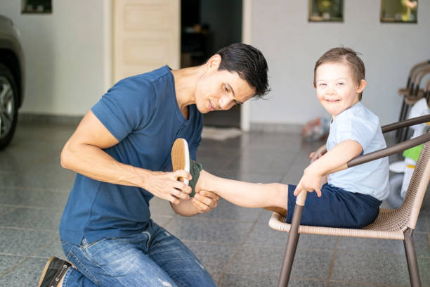istock Father preparing his son to go back to school. Down sindrome. 1269545005