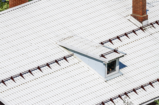 Top view white modern flat roof from texture corrugated metal with dormer window and smokestack