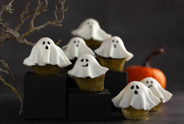 istock Halloween fondant ghost cupcakes on black podiums. 1269547885