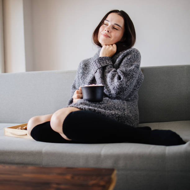 istock Woman enjoy hot chocolate on cozy home weekend 1269549641