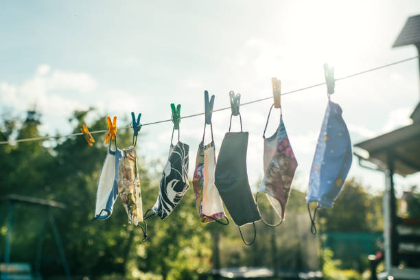 istock Reusable fabric protective face masks hanging outdoors and drying in a sunny day 1269551795