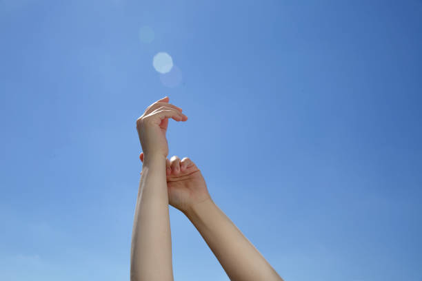istock Female hands stretching after waking up to the blue background 1269553203