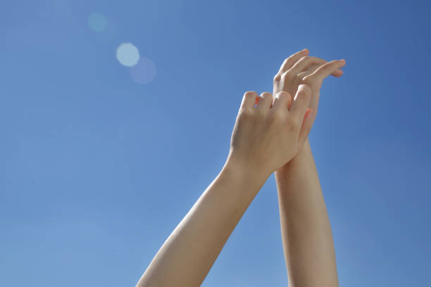 istock Female hands stretching after waking up to the blue sky 1269553207