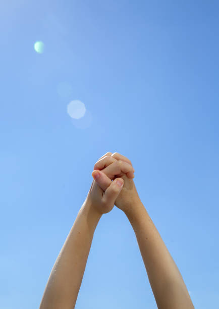 istock Closeup two young hands holding each other on the blue background 1269553218