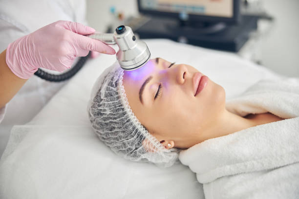 istock Doctor using a photo beauty device in cosmetology 1269556713