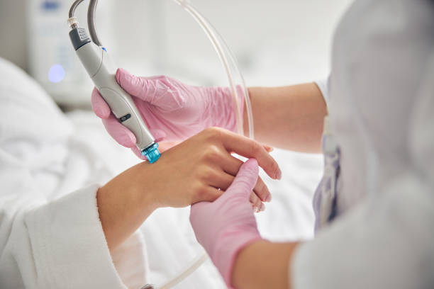 istock Doctor in sterile gloves using a dermabrasion device 1269556728