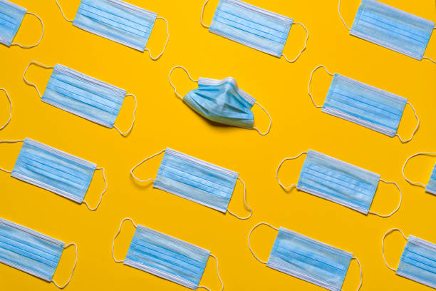 Medical masks isolated on a yellow background. Protective masks patterns