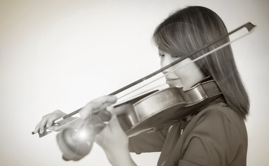 The blurry light design background of lady playing violin,Lens flare effect,vintage tone,blur motion