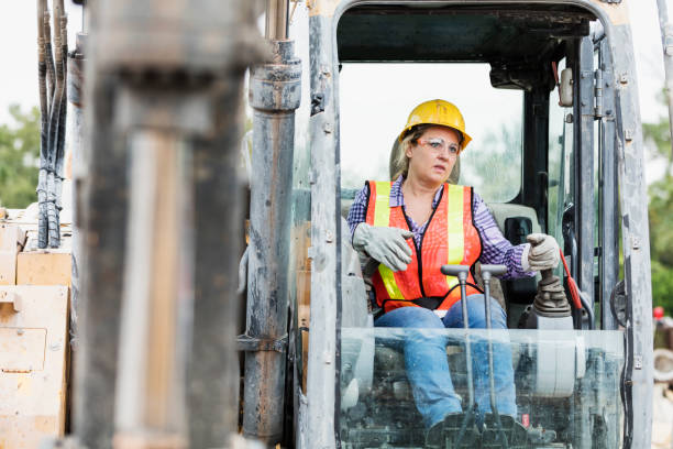 istock Hispanic female construction worker driving earth mover 1269560382