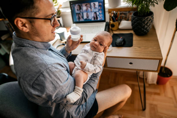 istock Father feeding baby during video conference call 1269561243