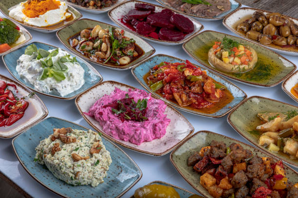 istock Traditional Turkish and Greek dinner meze table. Turkish Cuisine Cold Appetizers (appetizers with olive oil). Turkish appetizers in colorful plates. yogurt and various boiled herbs. 1269562500