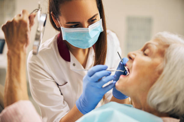 ritratto di dentista donna che tratta i denti di una paziente anziana - igienista dentale foto e immagini stock