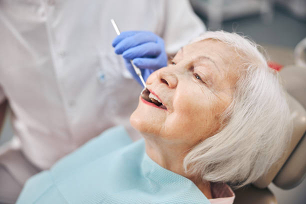 istock Senior beautiful woman is visiting her dentist 1269563477