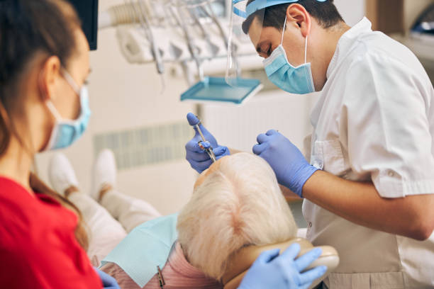 istock Dentist hands with blue gloves working with dental tools 1269563701