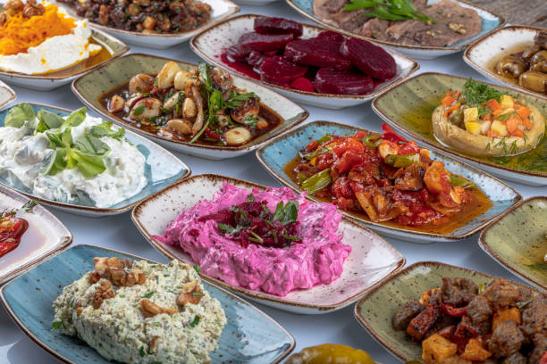 istock Traditional Turkish and Greek dinner meze table. Turkish Cuisine Cold Appetizers (appetizers with olive oil). Turkish appetizers in colorful plates. yogurt and various boiled herbs. 1269563733