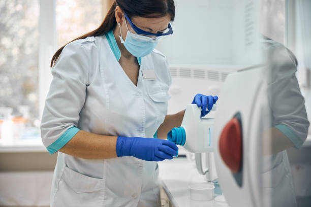 istock Female doctor with bottle of solution for work with instruments 1269564016