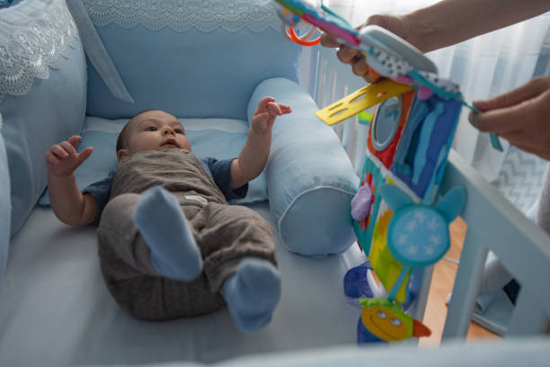 Mommy taking out baby toys because it’s time for sleeping.
