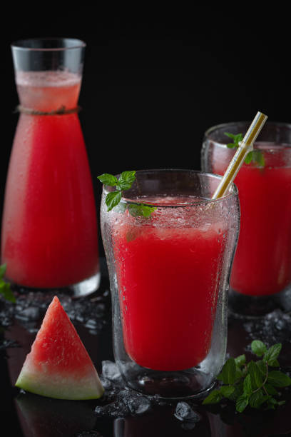 istock Summer cold drink with watermelon and mint on a black wooden background. Copy space 1269566952