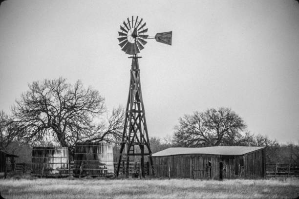 istock Old Texas wood windmill 2 cisterns barn trees pasture 1269567098