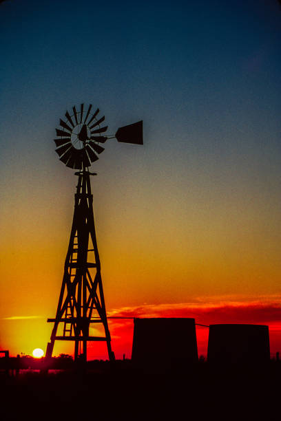 istock Old wood Texas windmill with 2 cisterns silhouetted in dramatic sky sunset 1269568126