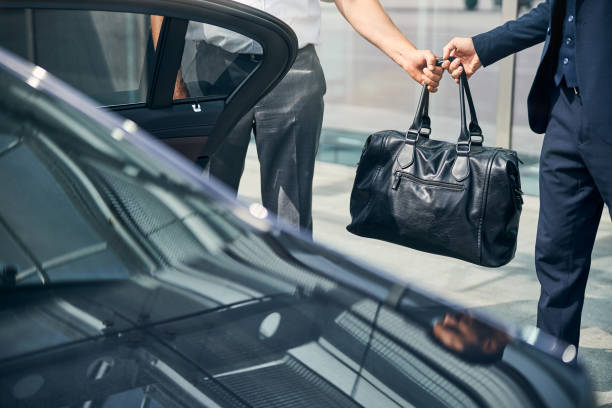 istock Taxi driver passing a duffel bag to a passenger 1269570256