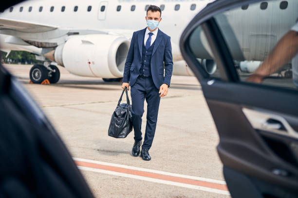 istock Young enterpreneur travelling safely with a mask on 1269570286