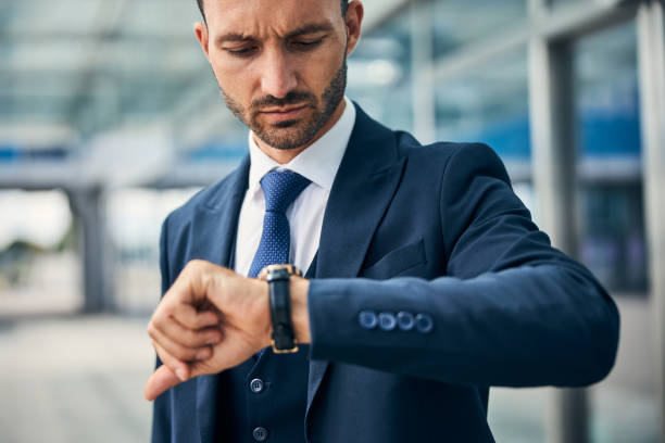 istock Serious man checking the time on his watch 1269570327