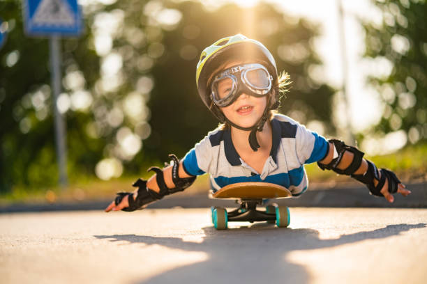 istock Cute boy with arms outstretched on skateboard 1269571390