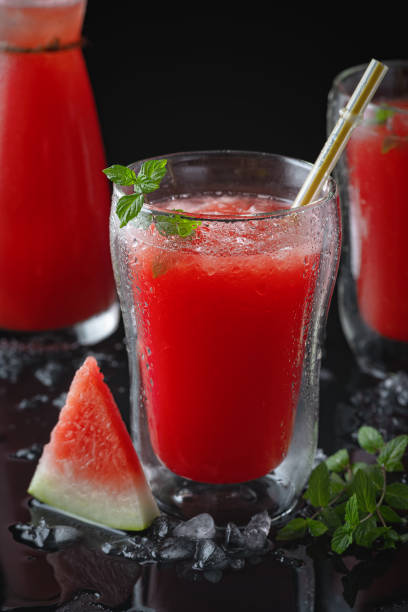 istock Summer cold drink with watermelon and mint on a black wooden background. Copy space 1269572363