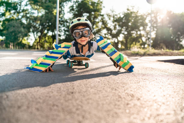istock Boy with flying goggles on skateboard 1269572381
