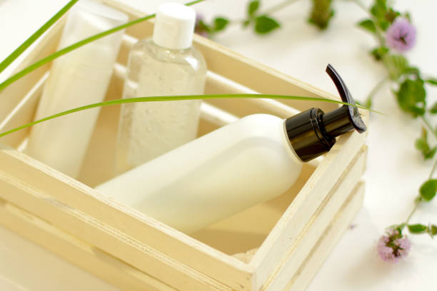 istock White plastic jar with green leaves on background 1269572606