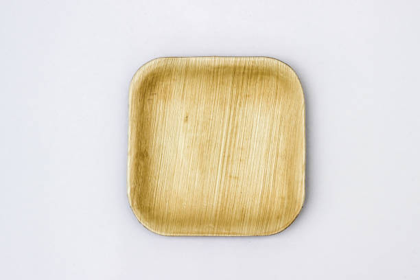 Square Areca Leaf Plate, eco-friendly disposable cutlery. Top view on a white background. syagrus stock pictures, royalty-free photos & images