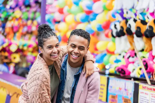 Photo of Young African-American couple playing carnival game