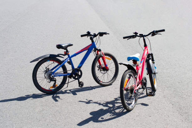 istock two multi-colored sports bicycles stand on the asphalt. 1269577206
