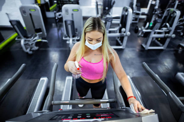 istock Gym staff is disinfecting exercise machine during Covid-19 pandemic 1269583137