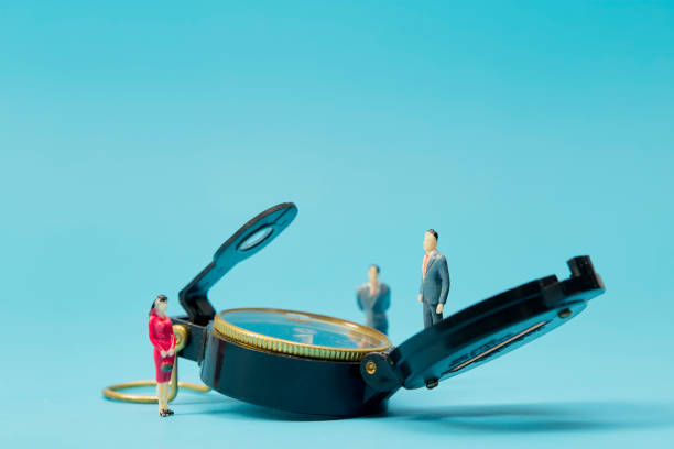 istock Miniature businessman and compass on blue background 1269584675