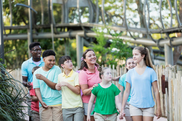 istock Summer field trip to zoo, including children with downs 1269592608