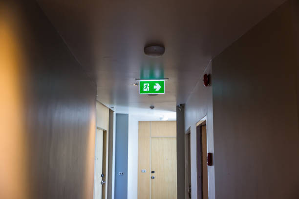 istock Green emergency exit sign showing the way to escape.Fire exit in the building. 1269593970