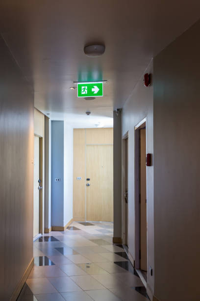 istock Green emergency exit sign showing the way to escape.Fire exit in the building. 1269593978