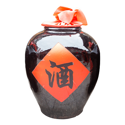 Jar of chinese white spirit,isolated on white background.The early Chinese, no glass bottles into China before, use this earthen jar filled with wine.The central character is the Chinese characters - 酒, that wine.