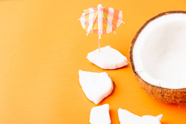 istock fresh coconut pieces slices and sun umbrella 1269597135