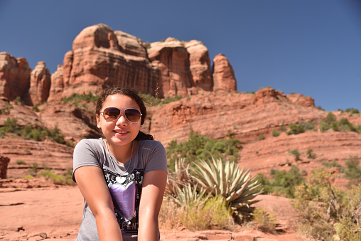 Young girl takes a break from hiking in Sedona, Arizona
