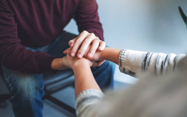 istock A man and a woman holding each other hands 1269608920
