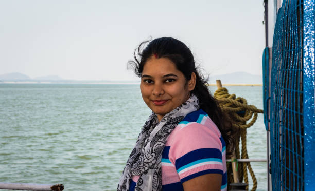 istock girl posing at ship deck with river horizon at evening 1269616654