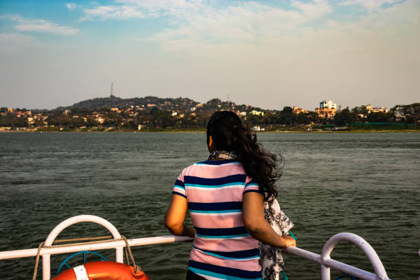 istock girl posing at ship deck with river horizon at evening 1269617195